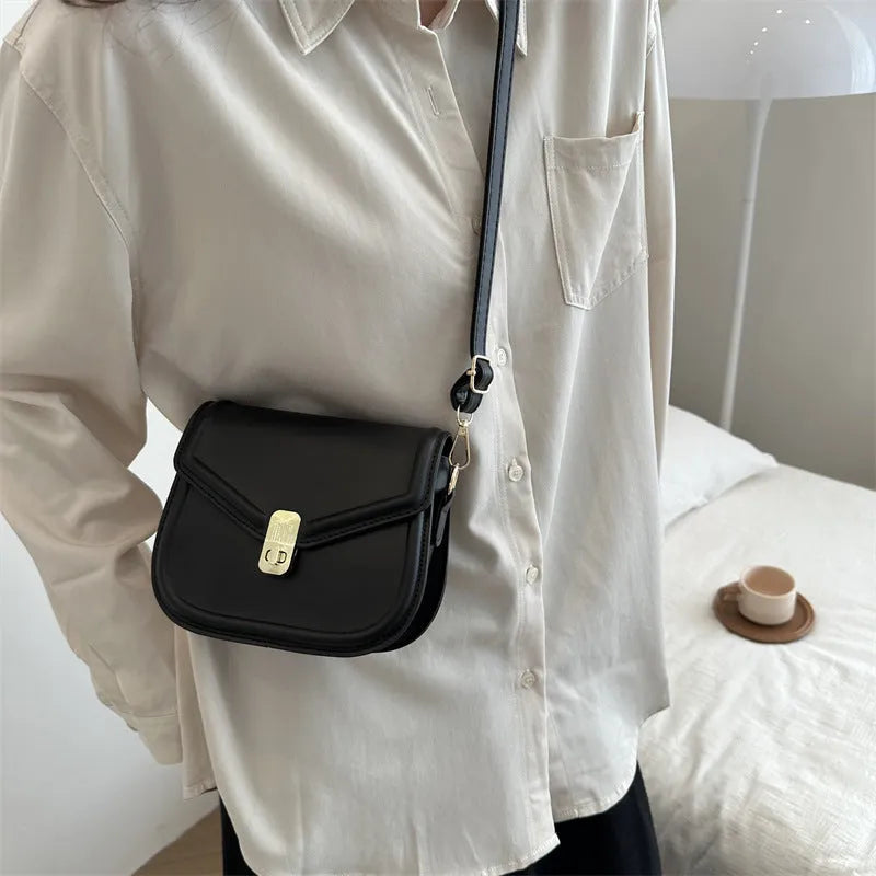 Soft PU leather clamshell messenger bag in a horizontal square shape on a shoulder strap.