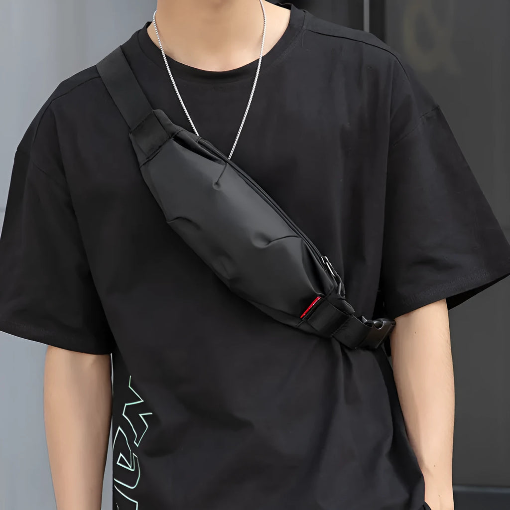 Black Oxford cloth men's waist pack with crossbody strap, shown with zipper open revealing phone and ID pockets.