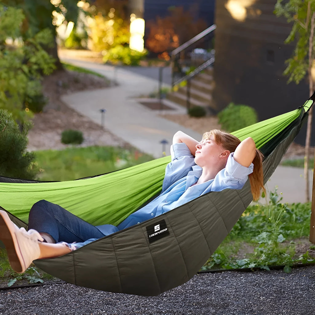 Army green outdoor camping hammock sleeping bag with compression sack, shown unrolled to display its size.