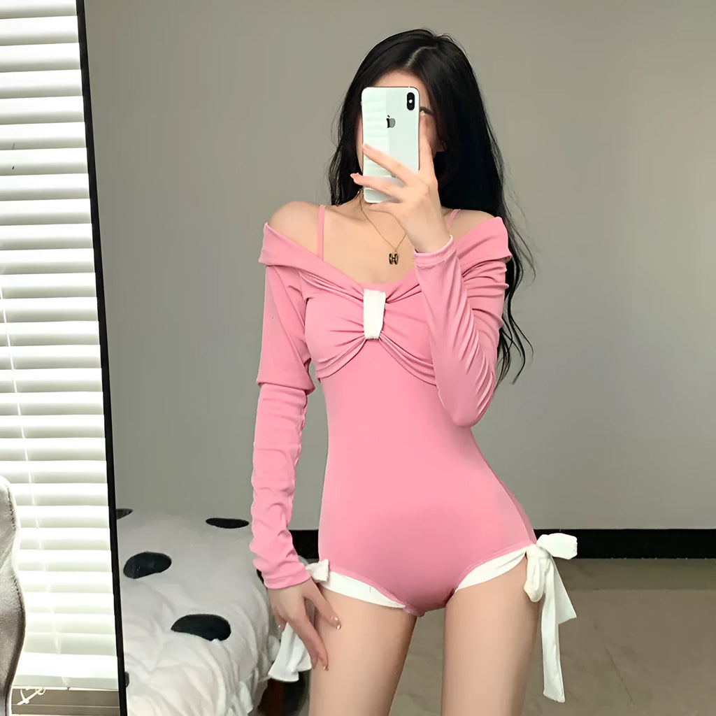 Women's long sleeve one-piece swimsuit in pink or black with figure-flattering design