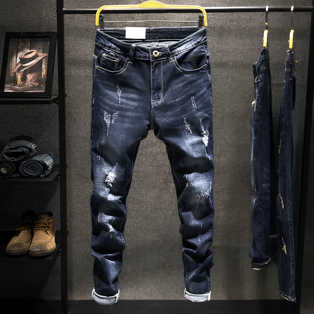 Men's slim-fit skinny jeans in dark blue cotton denim fabric on a hanger.