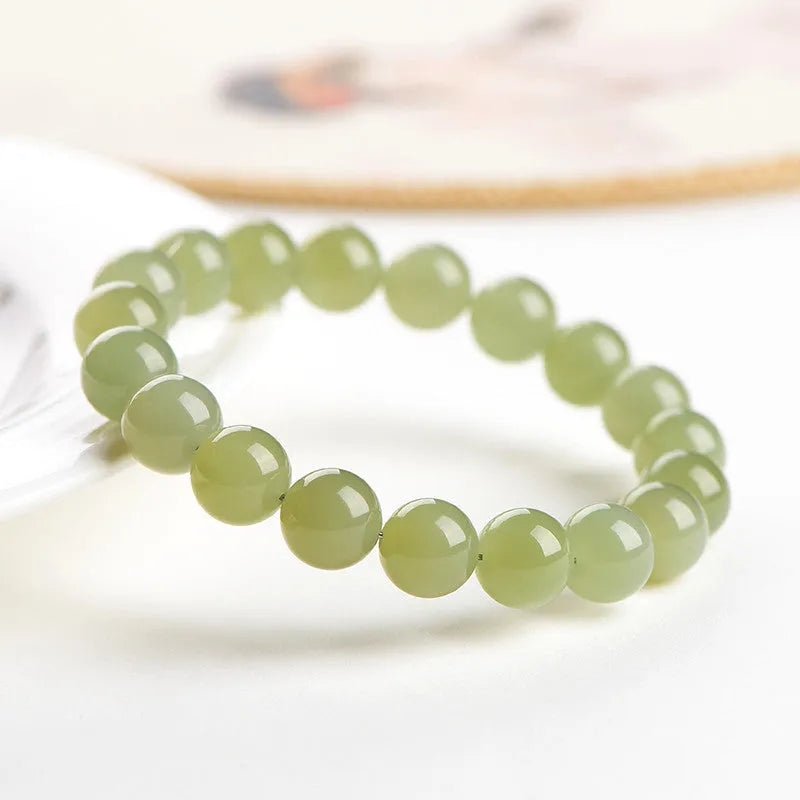 Hetian jade ball bracelet with spherical polished beads in clear colour tones