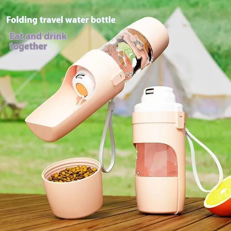 Green portable dog water bottle and feeder with attached lanyard, showing separate food and water compartments.