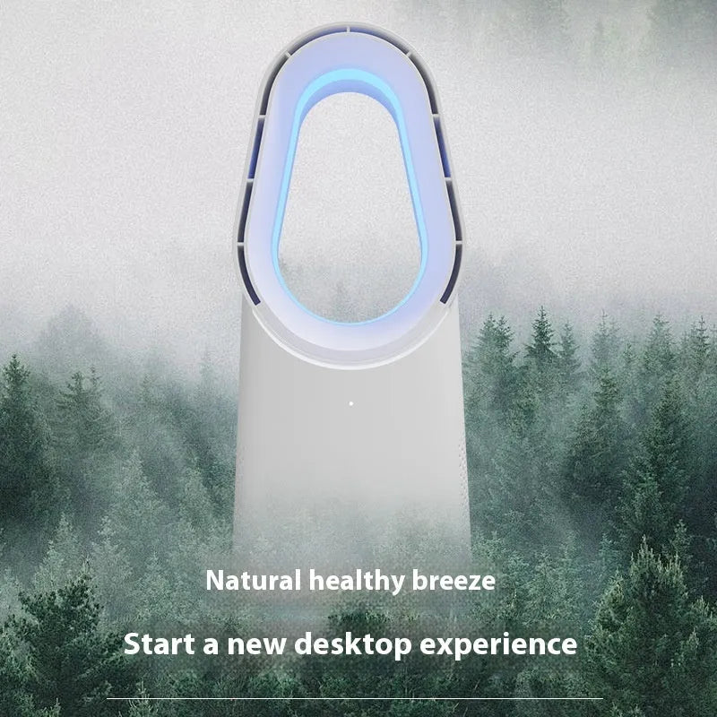 White bladeless tower fan with remote control on a wooden floor next to a desk.