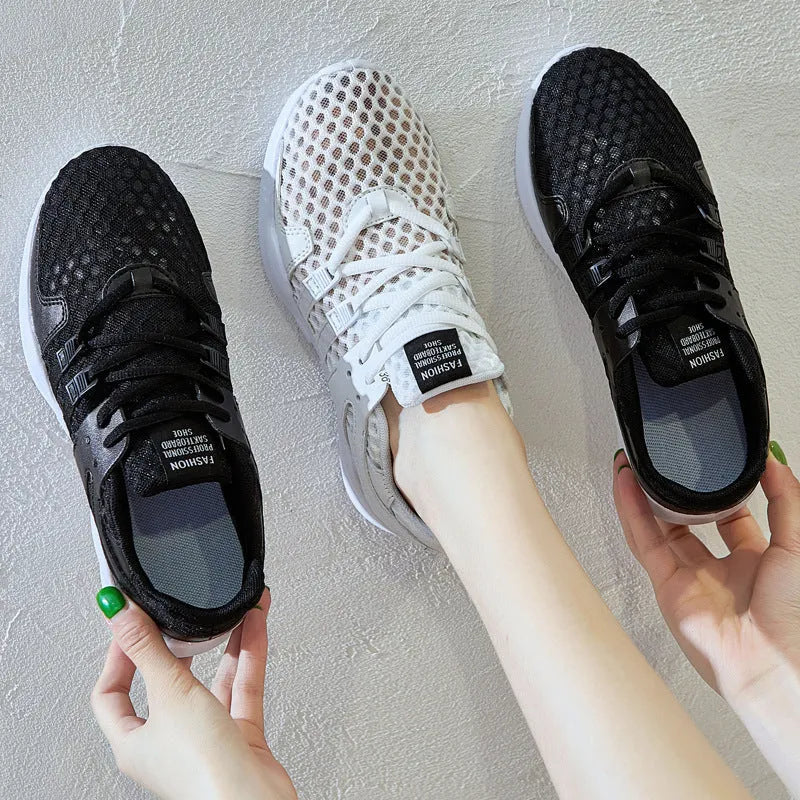 Women's low-top hollow mesh sneakers in white on a solid background.