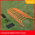 Set of six foldable yellow green and orange hexagon football agility training rings on grass