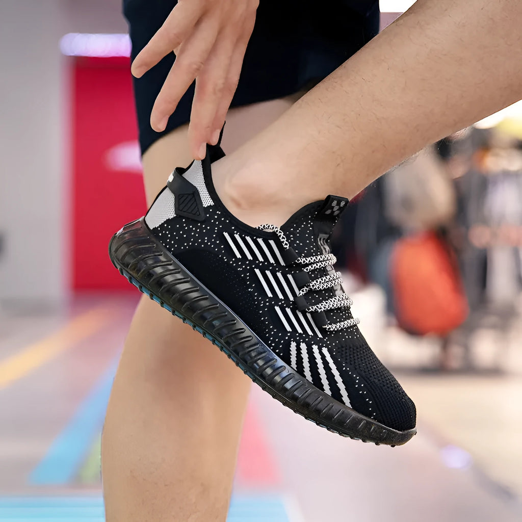 Men's white breathable flying fabric sports shoes with round toe and low-upper design.