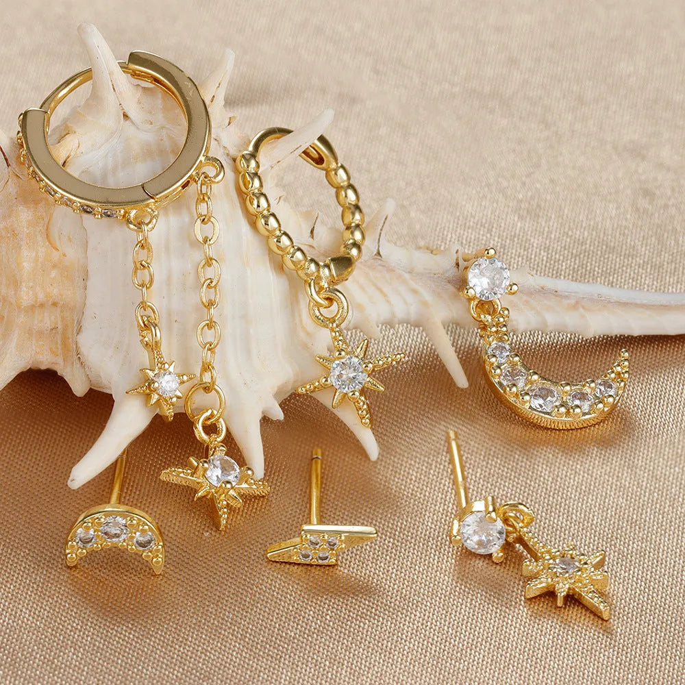 XINGX gold chain tassel earrings set with zircon stud accents, six individual pieces shown