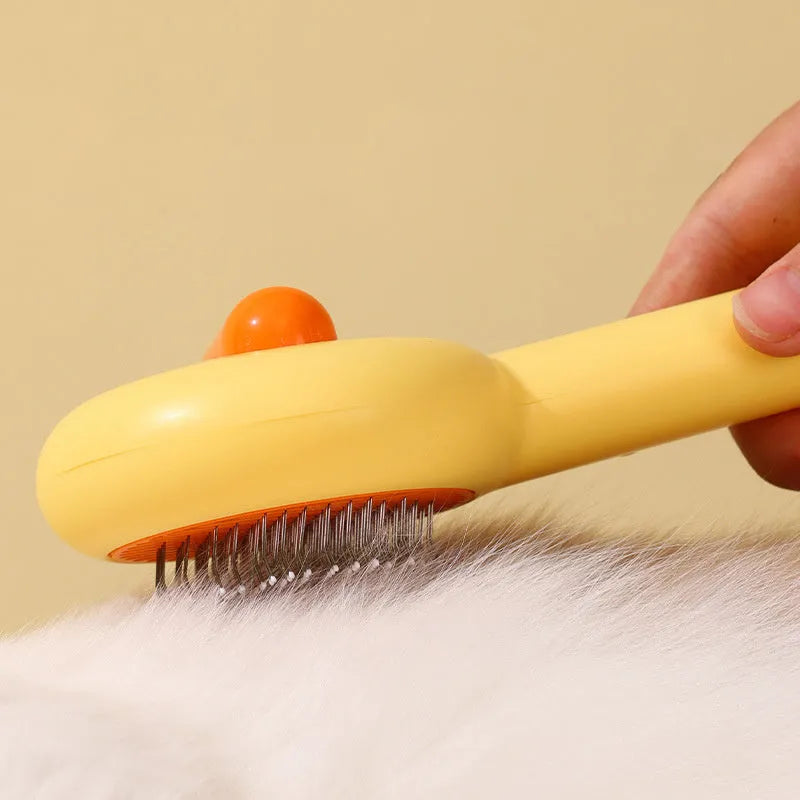 Small yellow duck-shaped pet comb with open and needle teeth for grooming cats and dogs.