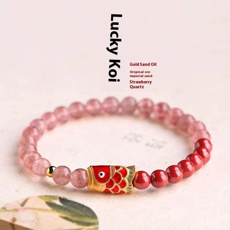 Purple and pink cinnabar and strawberry quartz beaded bracelet with peach blossom and koi designs.