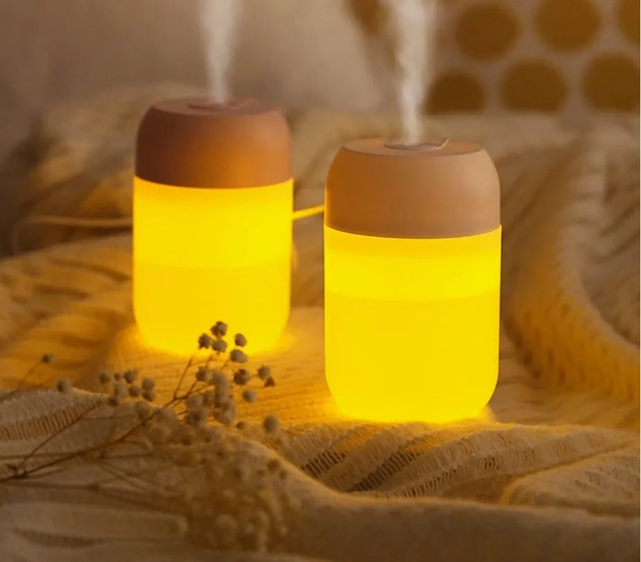 White cylindrical USB-powered mini humidifier with aromatherapy function on desk