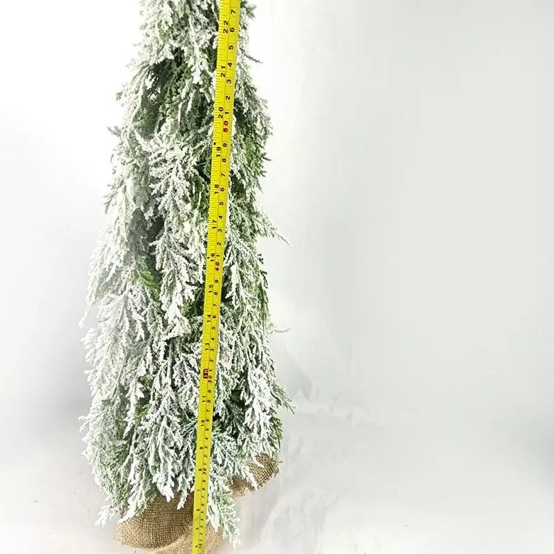 24-inch plastic artificial Christmas tree with snow sprayer and integrated lights on desktop