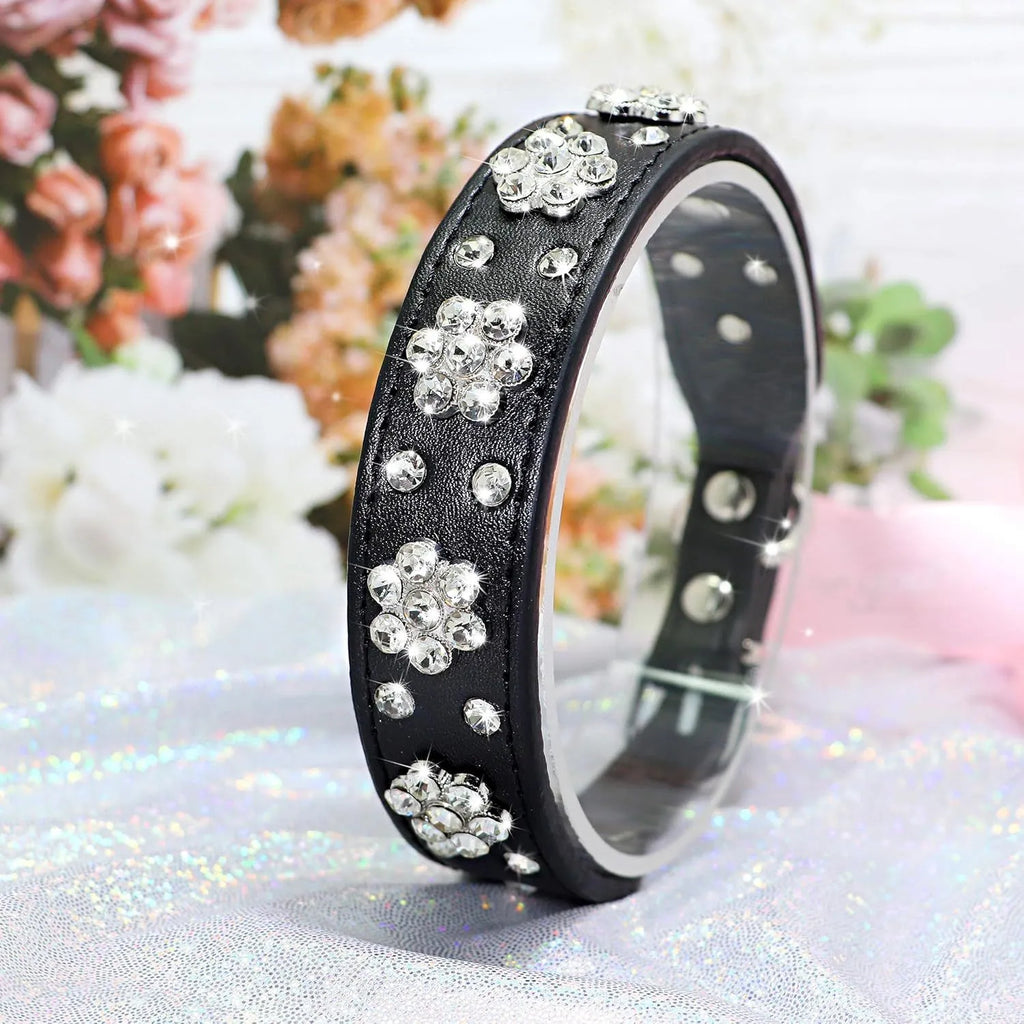 Black PU leather dog collar with silver rhinestone flower pattern and metal D-ring for small dogs.
