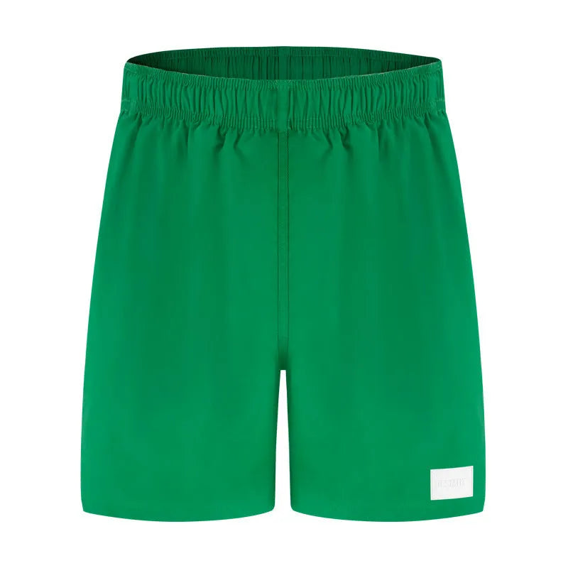 Men's nylon sports shorts in solid colours with straight leg opening and elastic waistband