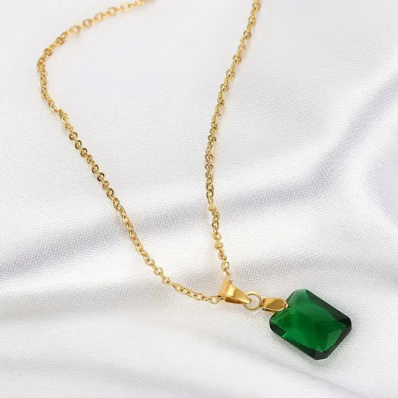 Copper rectangular geometric pendant necklace on an O-ring chain in a retro green colour.