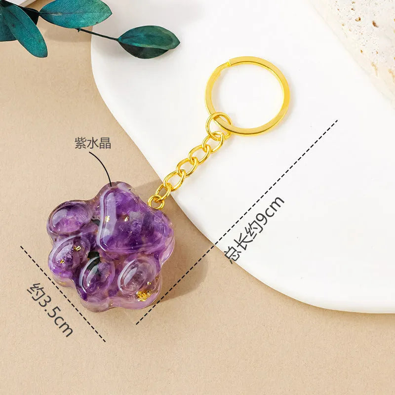 Small natural crystal cat's paw pendant on a metal keyring, available in various stone colours.