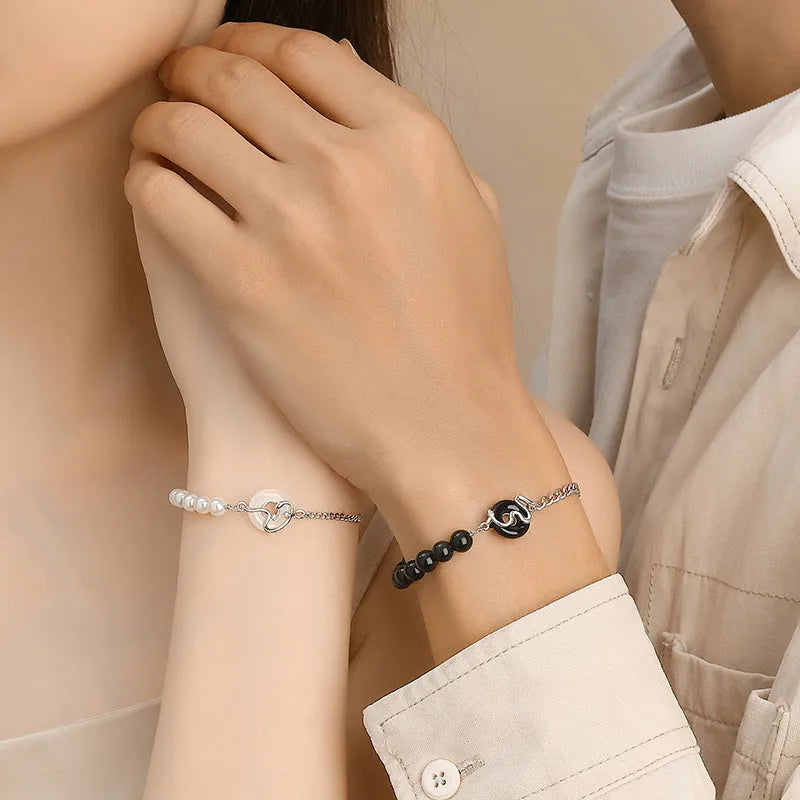 925 sterling silver couple bracelet with safe buckle, snake zodiac design, and obsidian pearl details in New Chinese style.