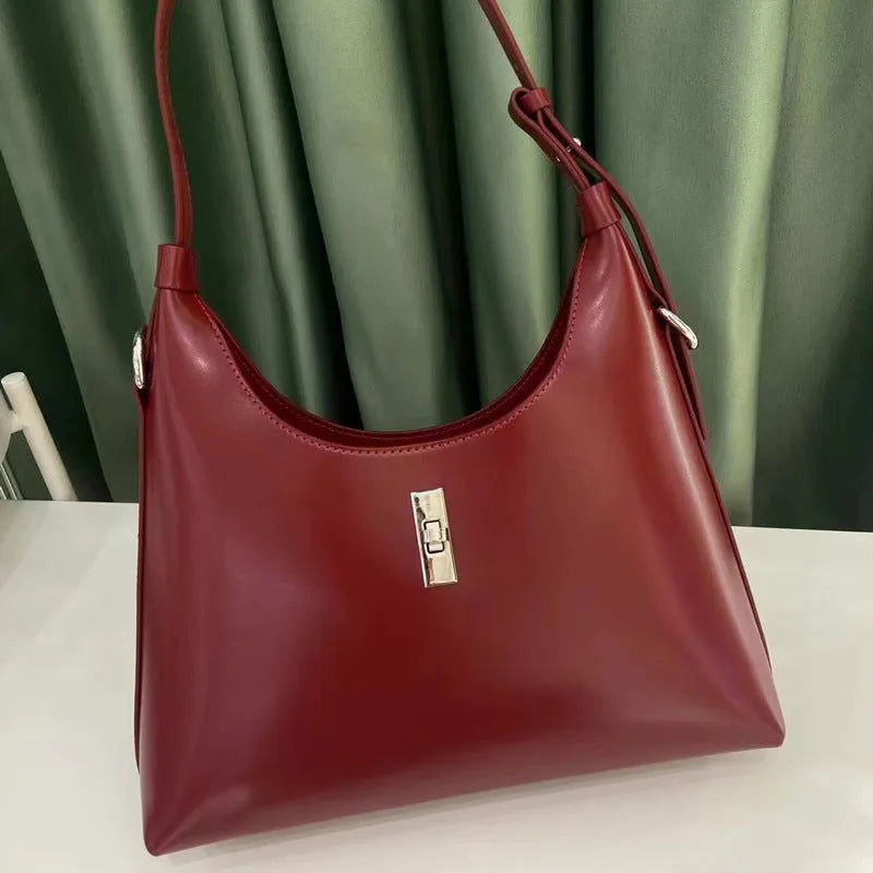Soft genuine leather dumpling-shaped crossbody shoulder bag in a street style with lock detail