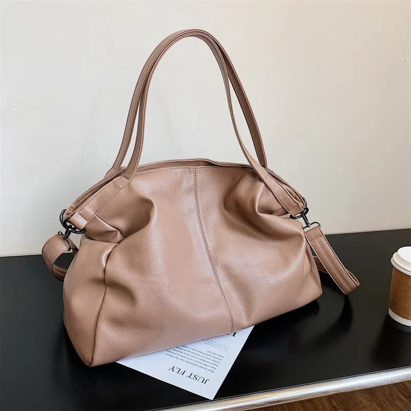 Large horizontal square soft-surface PU leather messenger bag with a long shoulder strap and zip opening.