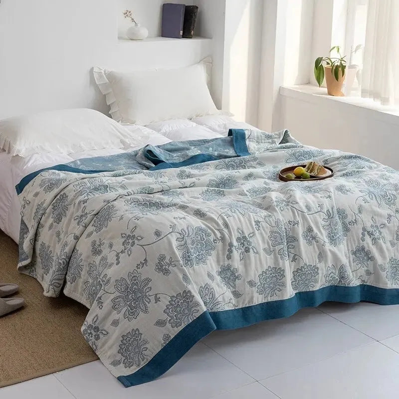 Pure cotton five-layer gauze bed blanket in roulette wheel blue pattern, shown in modern simple style.