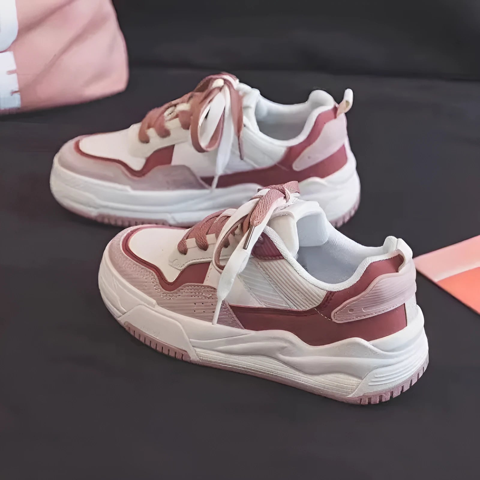 Beige and pink low-top sneakers with rubber soles and imitation leather lining