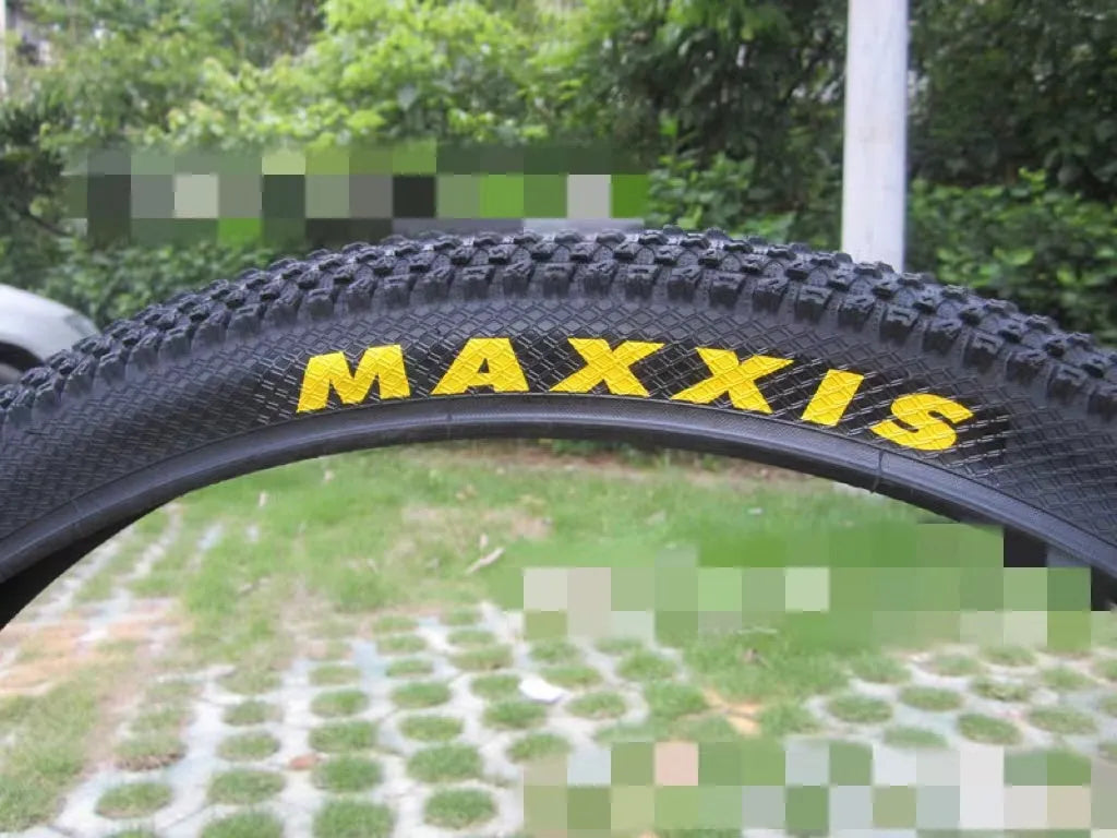 Ultralight puncture-resistant mountain bike tyre shown in black with white label option, for 26, 27.5 and 29-inch wheels.
