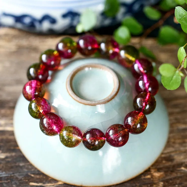 Handmade watermelon crystal bracelet for women on a wrist, showing pastoral design details.