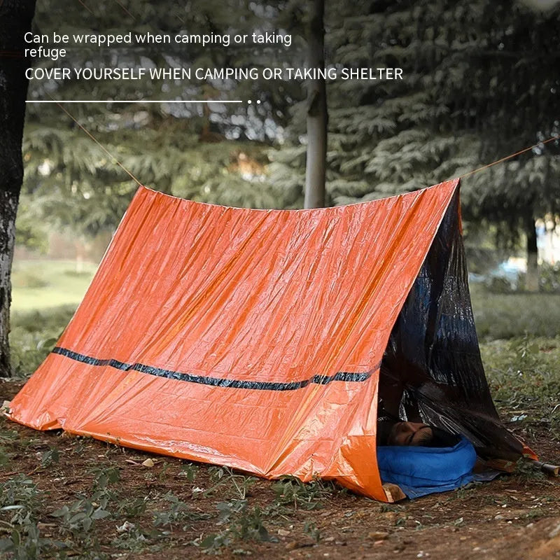 Orange emergency tent with sleeping bag and raincoat for disaster relief camping