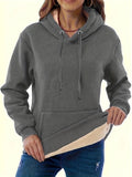 Women's loose black hooded sweater with pockets and a textured 3D pattern