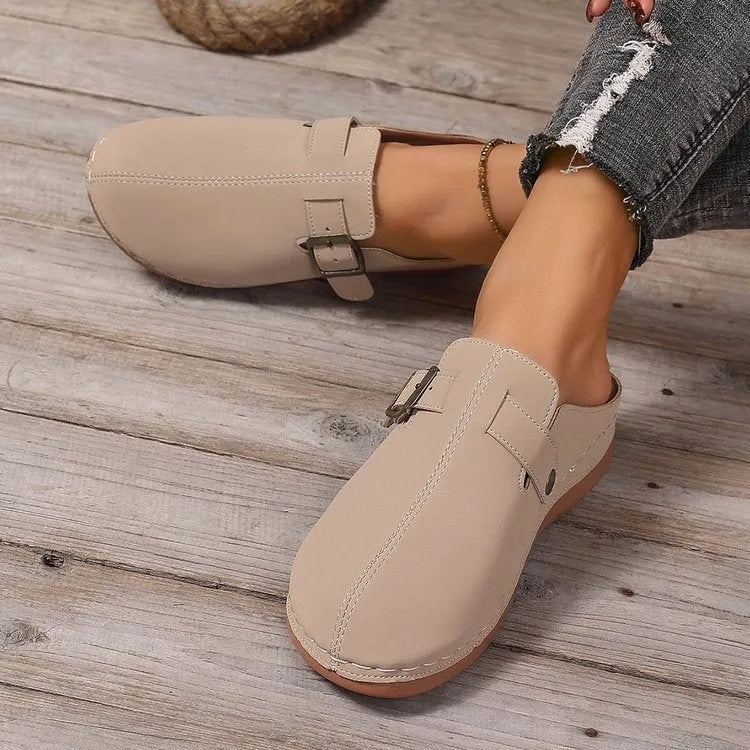 Women's casual wedge slipper in a light brown colour, showing cloth upper and rubber sole.