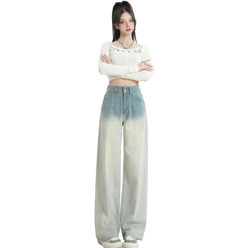 Gradient blue women's denim straight-leg trousers with a wide-leg fit on a hanger
