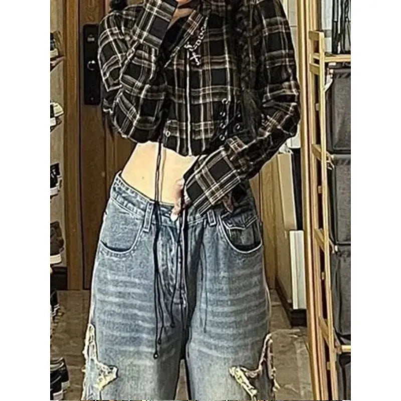 Blue high-waisted wide-leg denim trousers laid flat, showing straight cut and front detail.