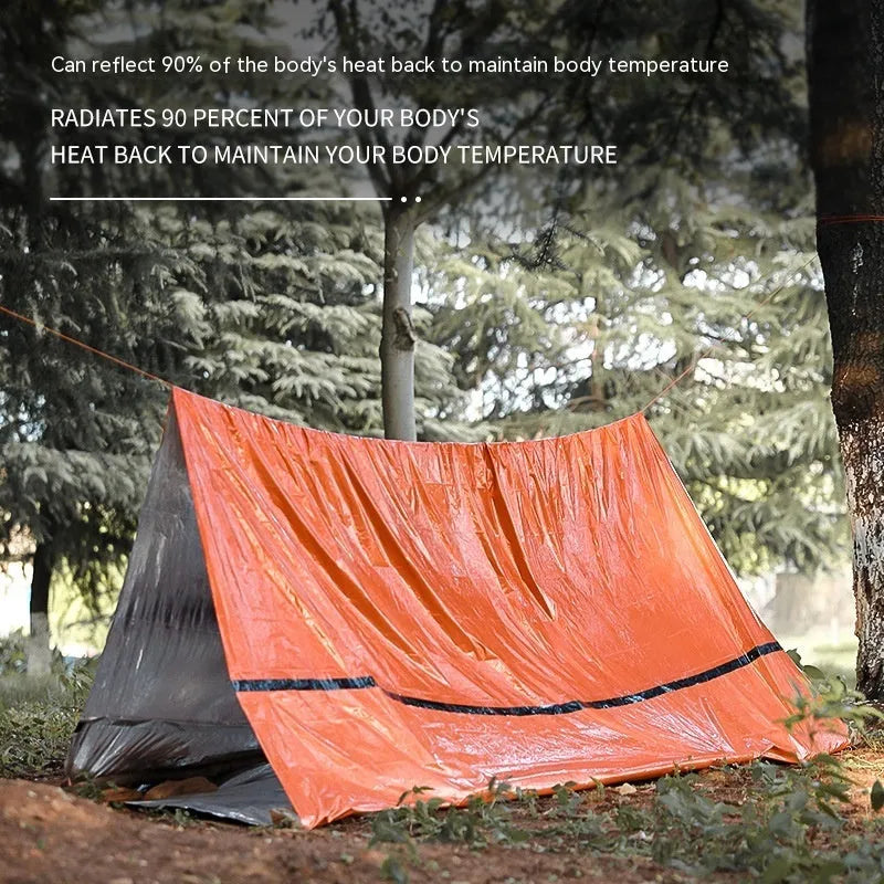 Orange emergency tent with sleeping bag and raincoat for disaster relief camping