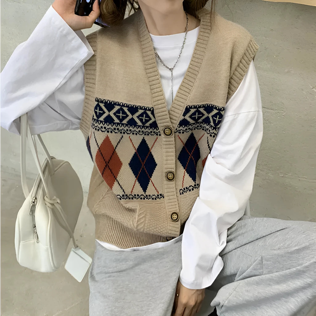 Woman wearing a sleeveless loose-fit cardigan top with a diamond plaid pattern in khaki.