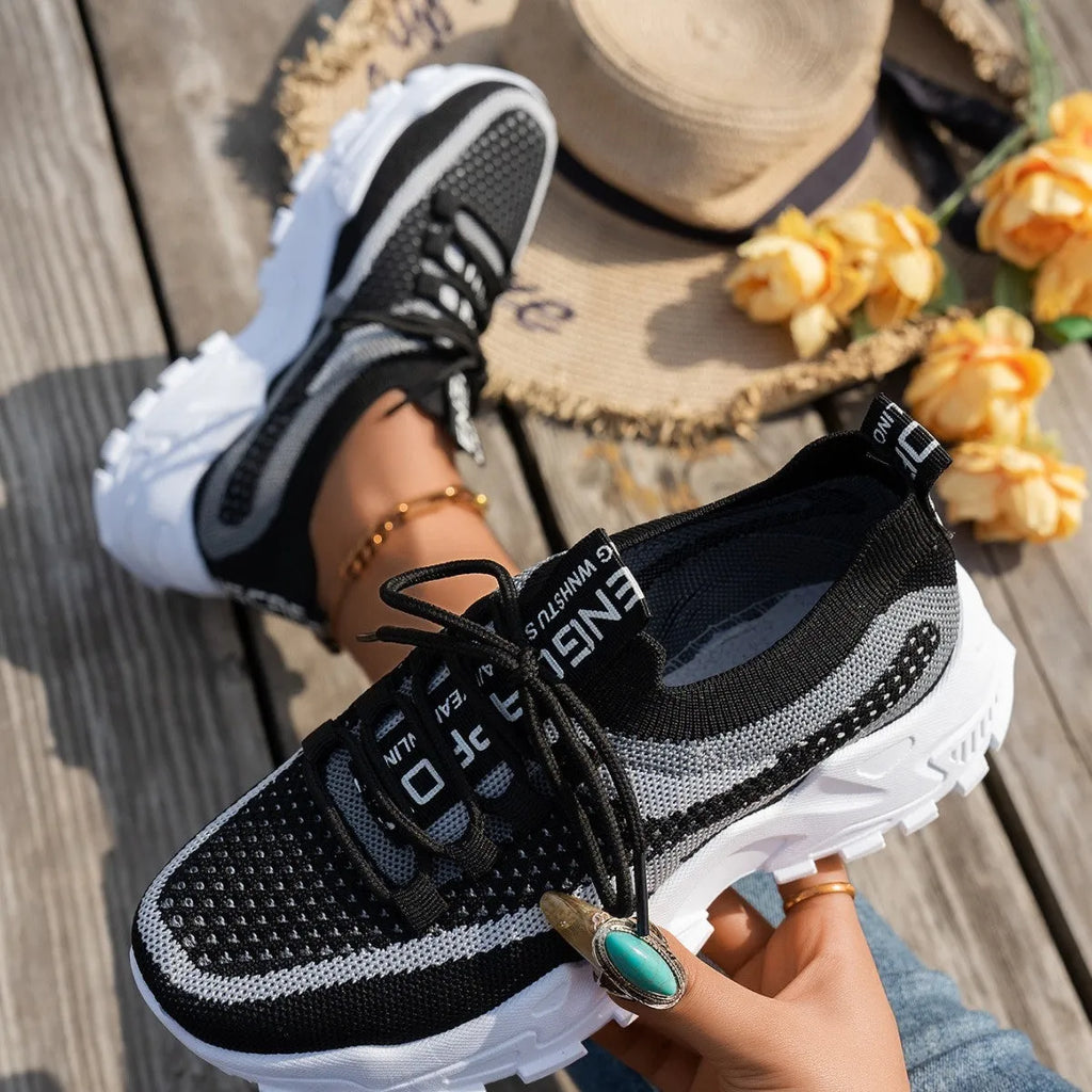 Women's Flyknit mesh lace-up sneakers in multiple colours with low flat rubber sole.