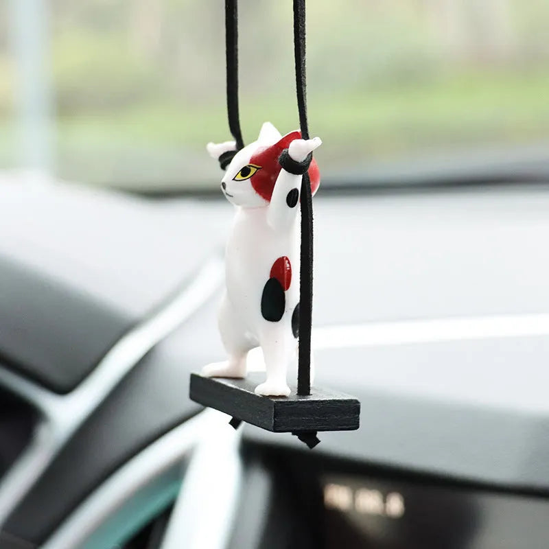 Cartoon-style resin cat pendant on an adjustable rope for car interior decoration.