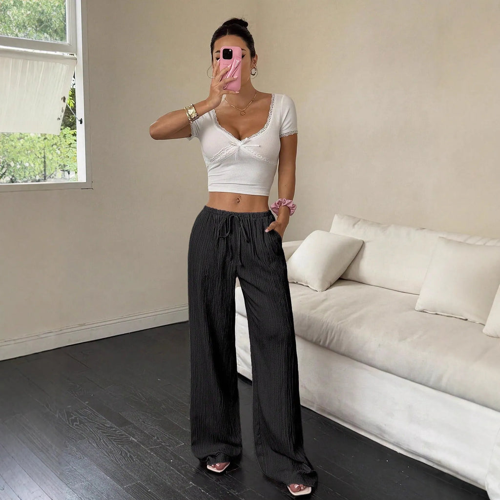 Women's black wide-leg trousers with lace-up waist detail front view
