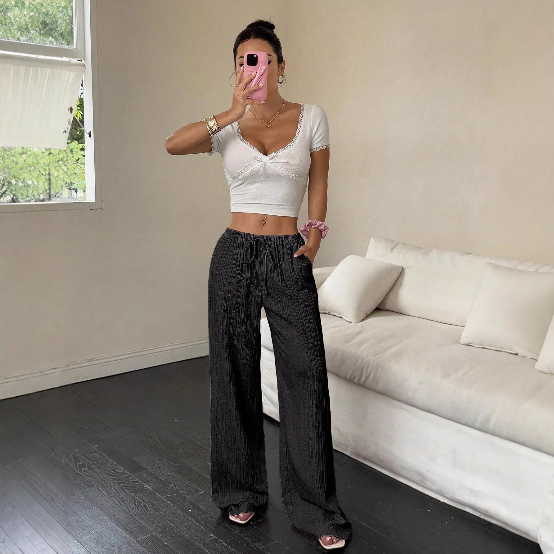 Women's black wide-leg trousers with lace-up waist detail front view