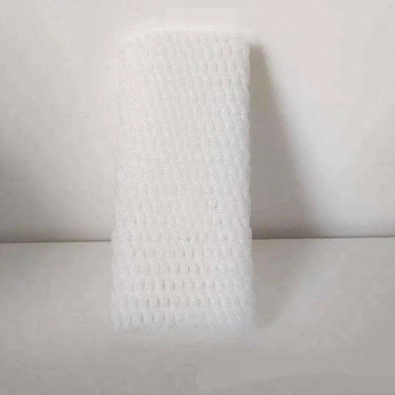 White foam protective net sleeves for fruit in assorted sizes on a table.