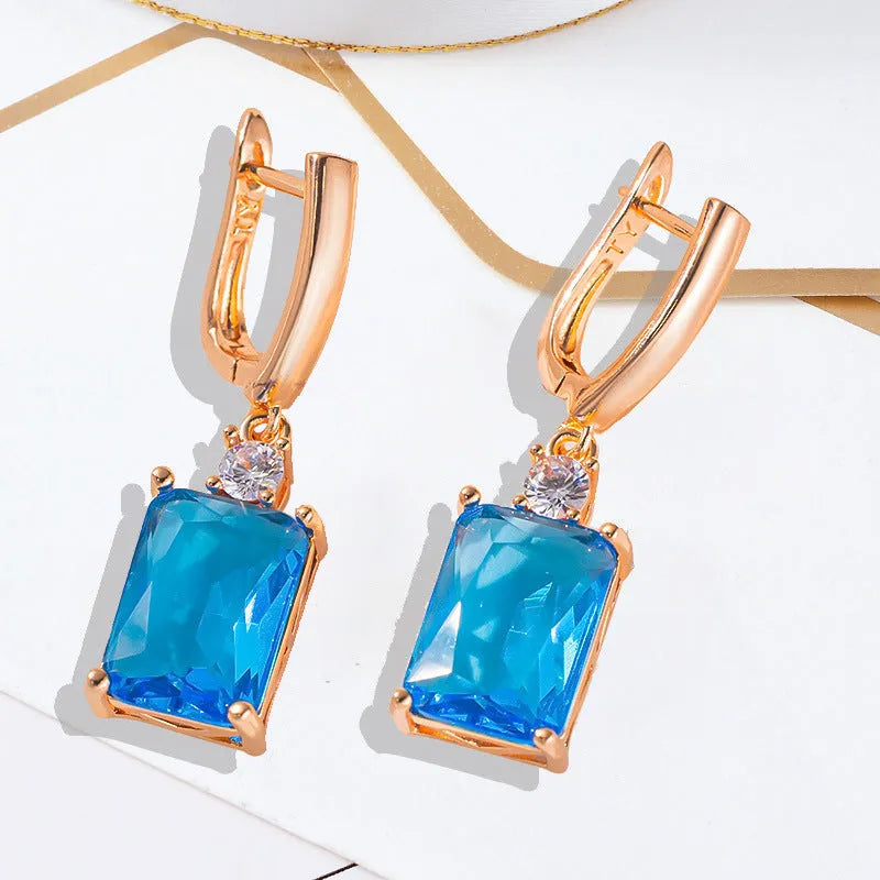 A pair of square geometric copper earrings with a gold electroplated finish.