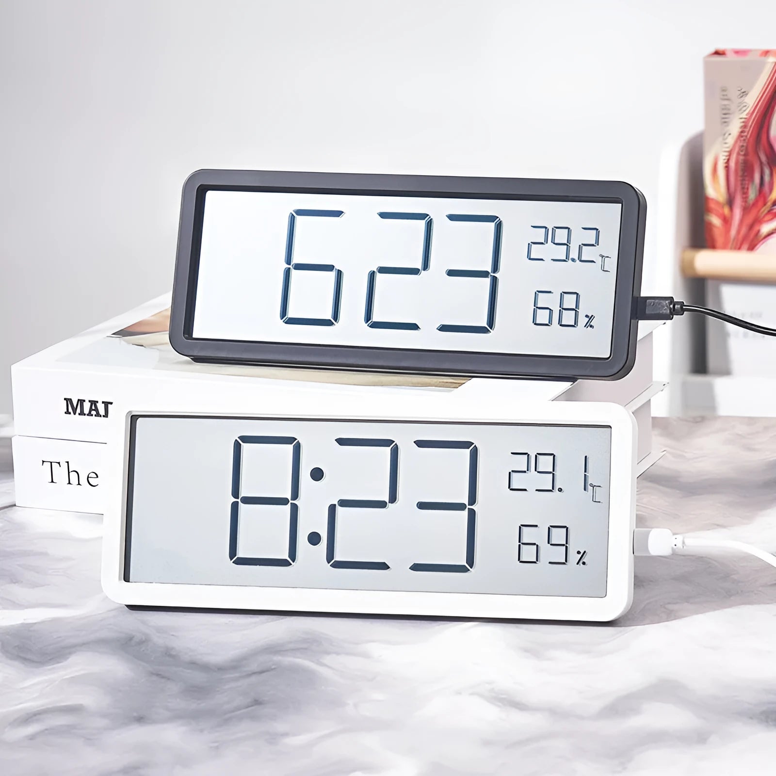 Simple large screen temperature and humidity clock in plastic with Nordic style, black colour, on a desk.