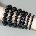 Hand-woven obsidian couples bracelet with year of birth engraving and multiple bead diameter options