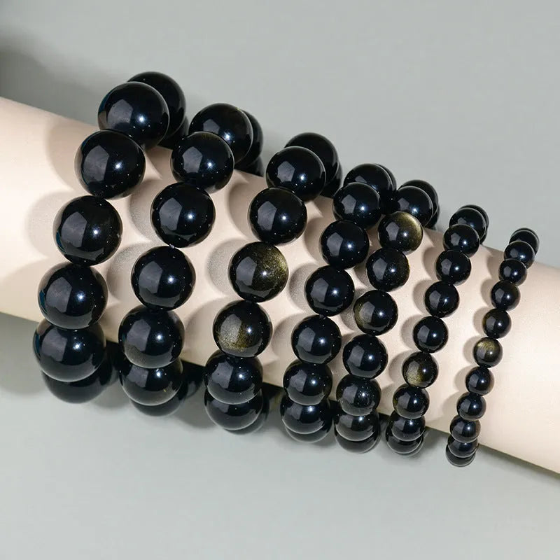 Hand-woven obsidian couples bracelet with year of birth engraving and multiple bead diameter options
