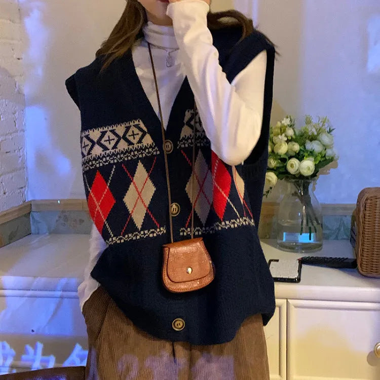 Woman wearing a sleeveless loose-fit cardigan top with a diamond plaid pattern in khaki.