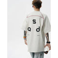 Loose fit black cotton t-shirt with white letter print, short sleeves, and round neck.