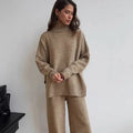 Women's dark grey acrylic knit sweater and trouser suit with a side-slit design on the top.
