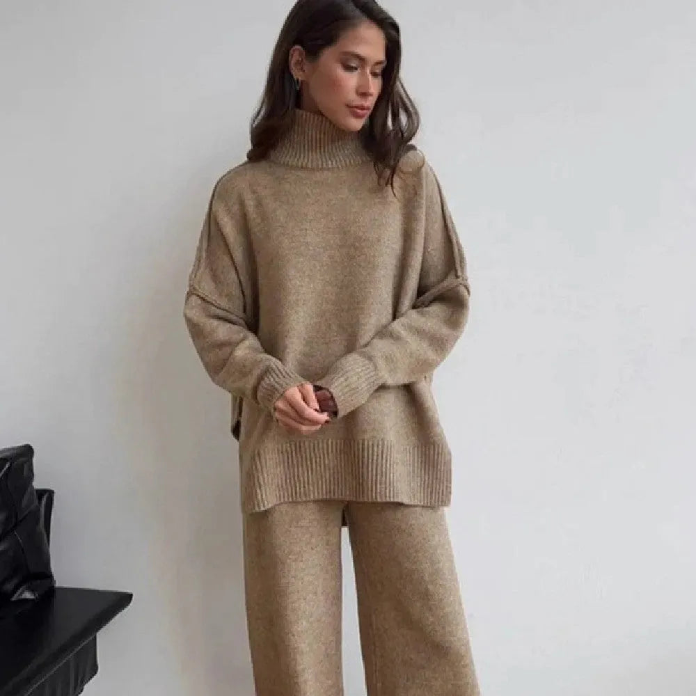 Women's dark grey acrylic knit sweater and trouser suit with a side-slit design on the top.