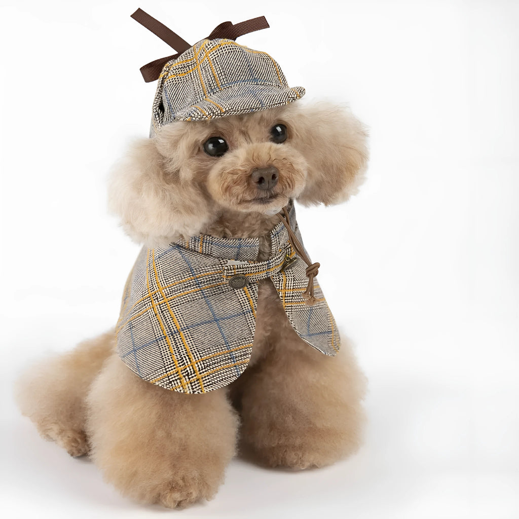 Camel coloured cotton detective cloak for dogs on a hanger, showing the adjustable hat.