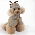 Camel coloured cotton detective cloak for dogs on a hanger, showing the adjustable hat.
