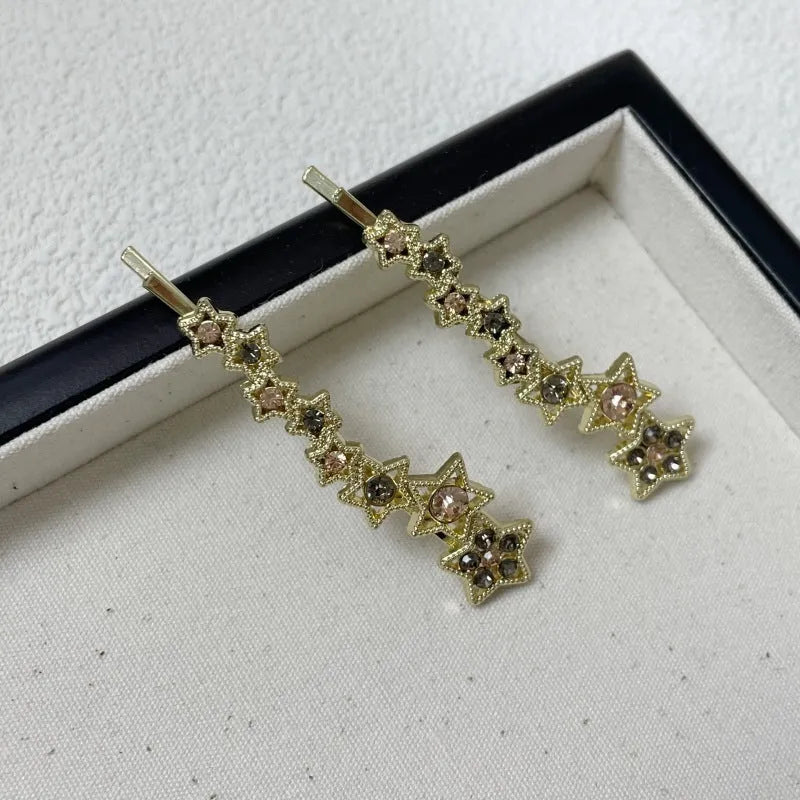 Gold electroplated alloy rhinestone barrettes with side clip bangs design and five-pointed star charms